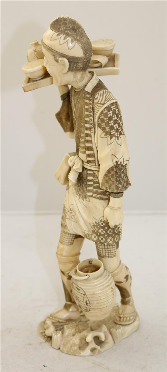 A large Japanese sectional walrus ivory figure of a man, early 20th century, 32cm